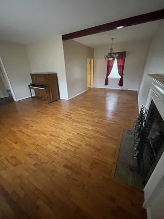 a view of empty room with window and fireplace