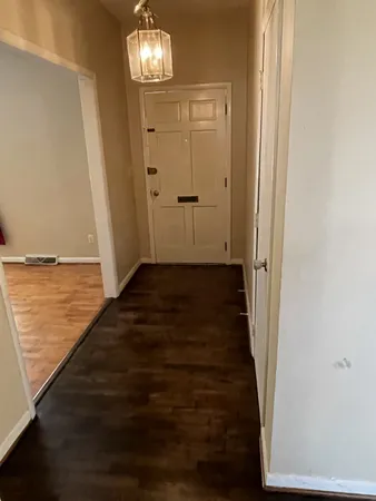 a view of a hallway with wooden floor