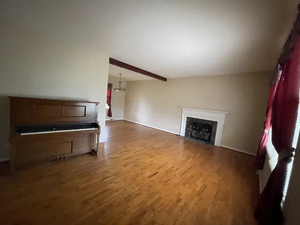 a view of an empty room with a fireplace