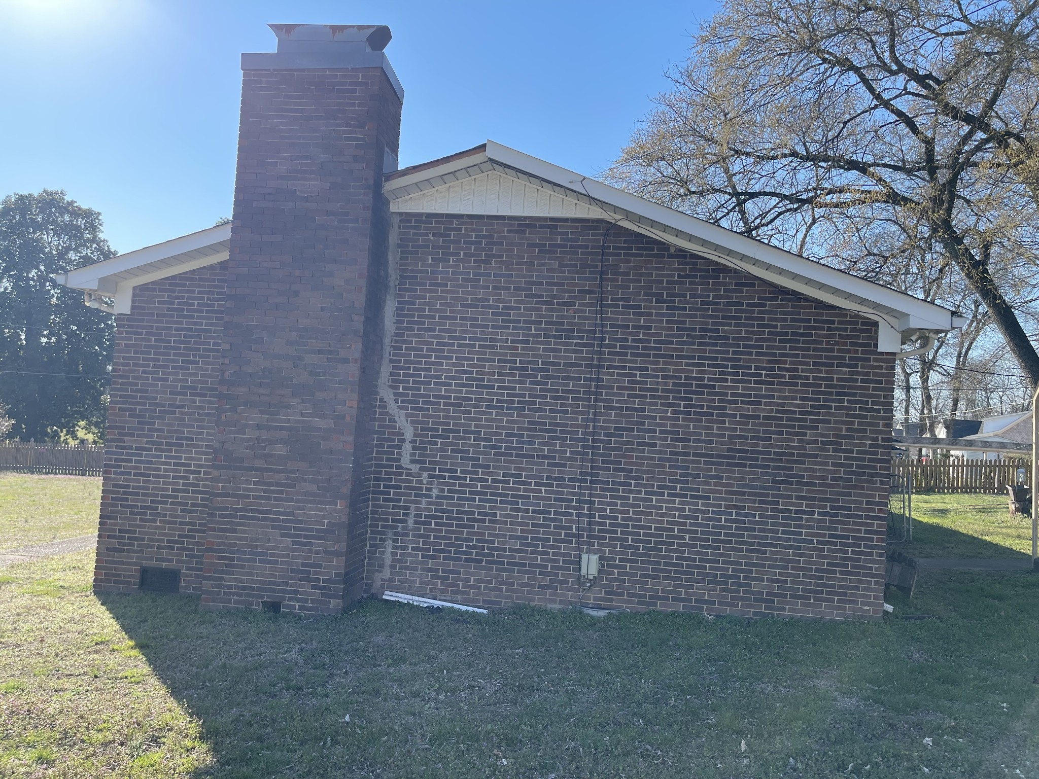 550 East Jefferson Street Pulaski, TN 38478 - Photo 4 of 23 a brick house with a small yard and large trees