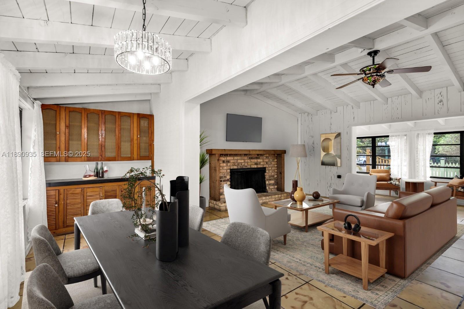 6031 Southwest 82nd Avenue Miami, FL 33143 - Photo 12 of 42 a living room with furniture a chandelier and a fireplace