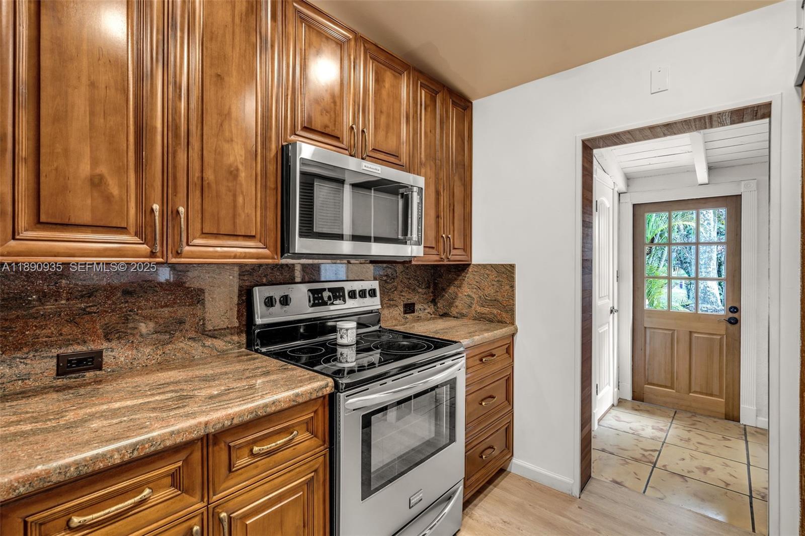 6031 Southwest 82nd Avenue Miami, FL 33143 - Photo 16 of 42 a kitchen with stainless steel appliances granite countertop a stove a microwave and a sink
