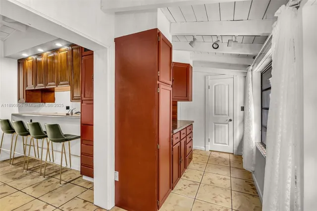 a kitchen with a sink a stove and cabinets