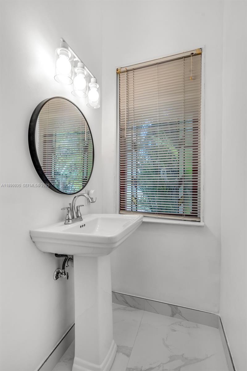 6031 Southwest 82nd Avenue Miami, FL 33143 - Photo 26 of 42 a bathroom with a sink and mirror