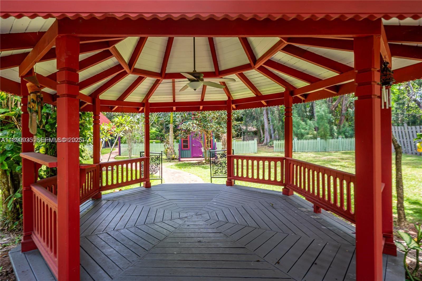 6031 Southwest 82nd Avenue Miami, FL 33143 - Photo 30 of 42 a view of a patio with a table and chairs under an umbrella with a small yard
