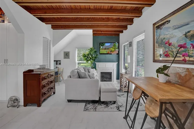 a bath room with a table and a potted plant