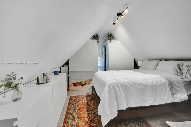 an aerial view of a house with a yard and lake view