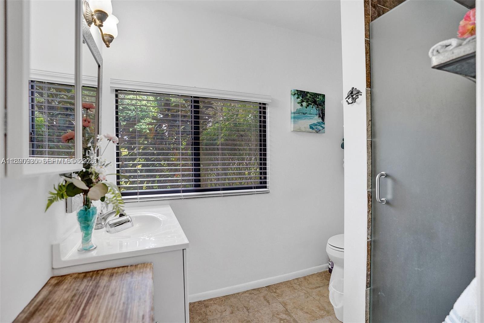 6031 Southwest 82nd Avenue Miami, FL 33143 - Photo 40 of 42 a bath room with a table and a potted plant