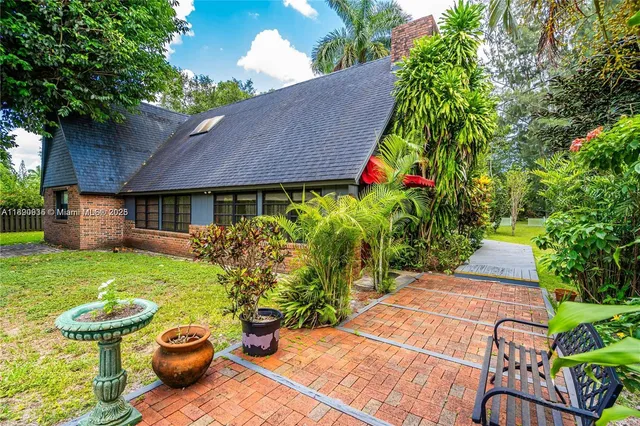 a view of a backyard with plants and a garden