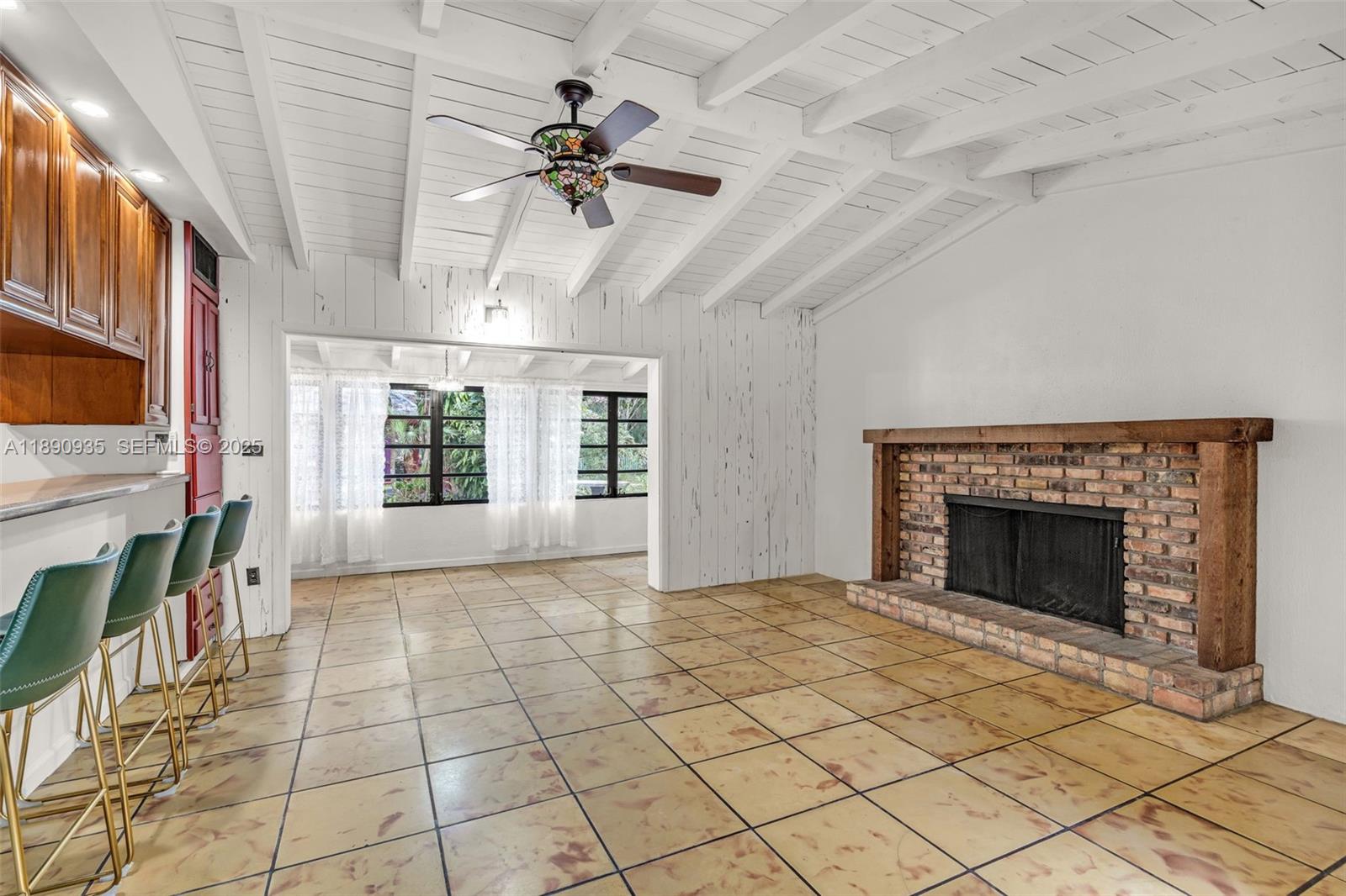 6031 Southwest 82nd Avenue Miami, FL 33143 - Photo 9 of 42 a view of an empty room with a fireplace and a window
