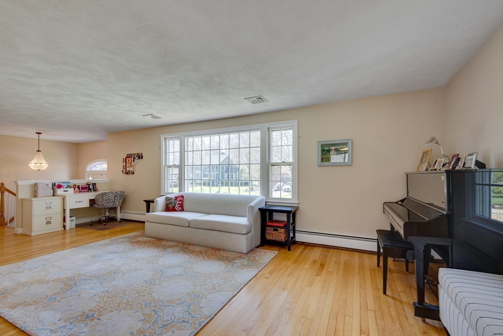 6 Apollo Circle Lexington, MA 02421 - Photo 15 of 38 a living room with furniture and a wooden floor