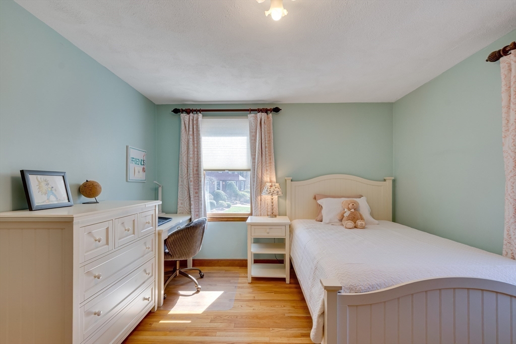 6 Apollo Circle Lexington, MA 02421 - Photo 20 of 38 a bedroom with a bed and wooden floor