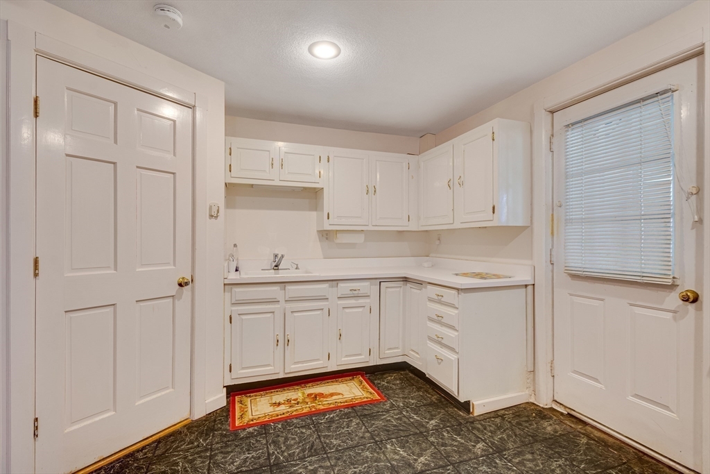 6 Apollo Circle Lexington, MA 02421 - Photo 28 of 38 a kitchen with granite countertop white cabinets and white appliances
