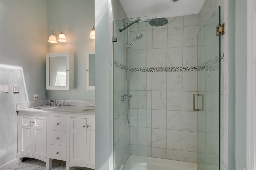 6 Apollo Circle Lexington, MA 02421 - Photo 30 of 38 a bathroom with a granite countertop sink a mirror and shower