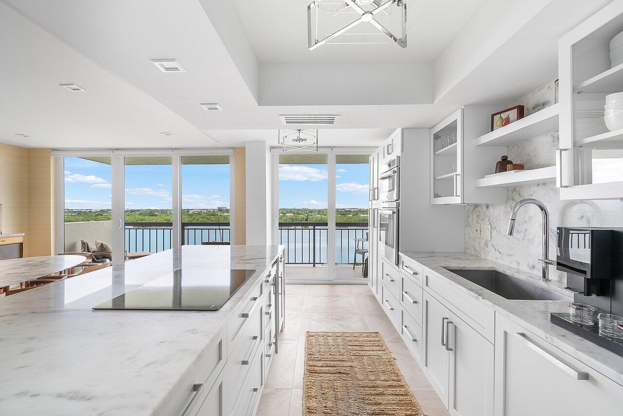 2003 North Ocean Boulevard, Unit 905 Boca Raton, FL 33431 - Photo 32 of 59 a large white kitchen with a large window