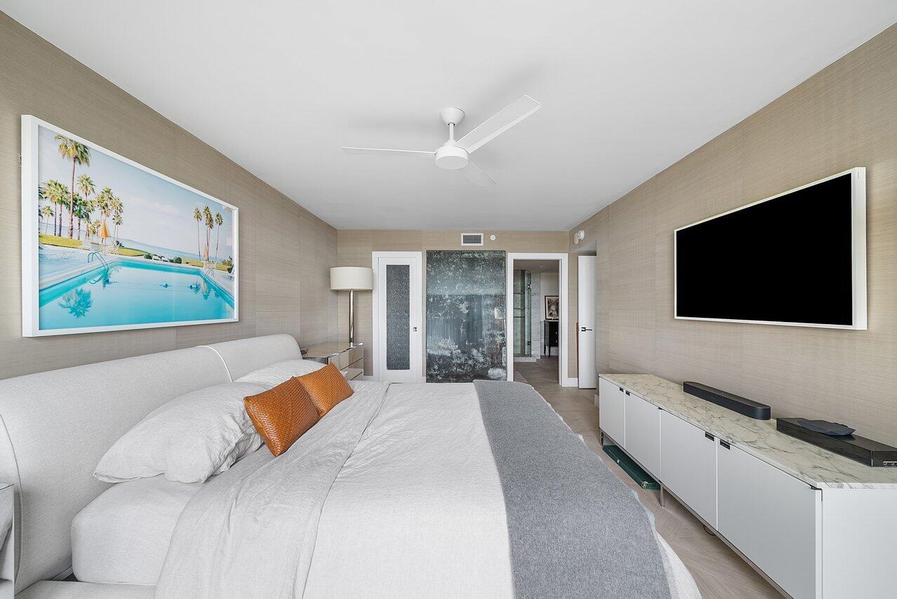 2003 North Ocean Boulevard, Unit 905 Boca Raton, FL 33431 - Photo 40 of 59 a bedroom with a bed and a flat screen tv