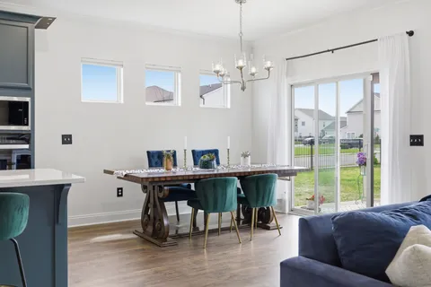a living room with fireplace furniture and a large window