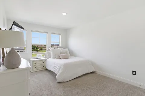 a bedroom with a bed and a mirror