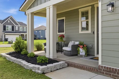 a view of a house with backyard and sitting area