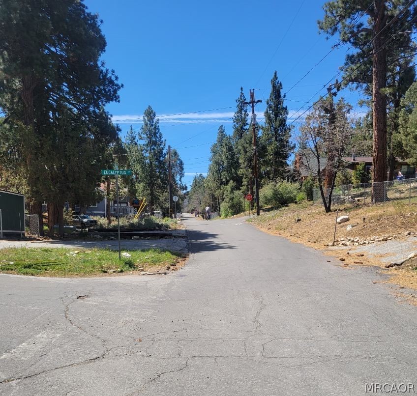 0 Riverside Lane Sugarloaf, CA 92386 - Photo 2 of 2 a view of a playground with a house and trees in the background