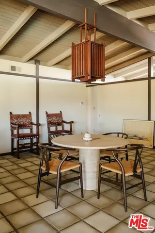 a view of a chairs and table in the balcony