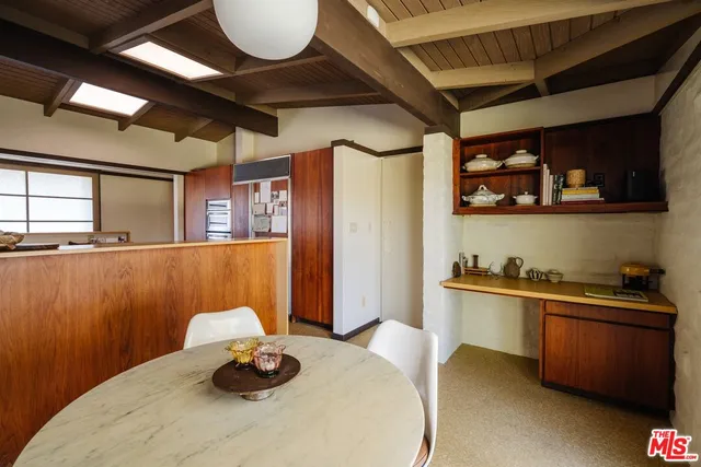 a kitchen with stainless steel appliances granite countertop a sink a stove and wooden cabinets