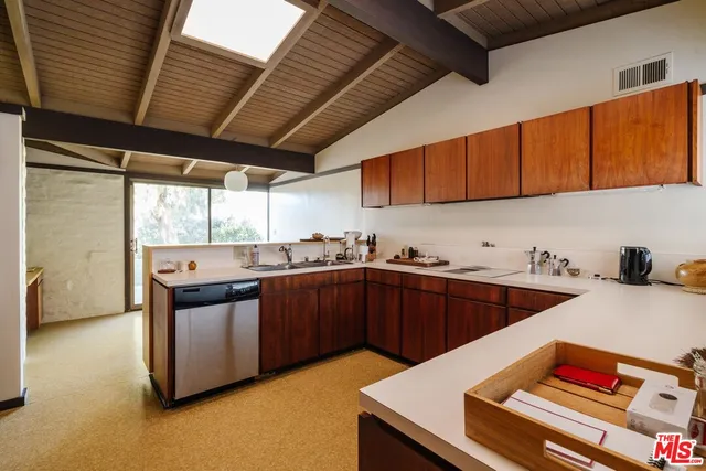 a kitchen with stainless steel appliances granite countertop a sink and wooden cabinets