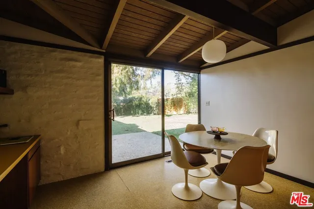 a dining room with furniture and wooden floor