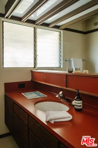 a bathroom with a sink and a window