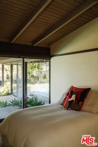 a bed sitting in a room next to a window