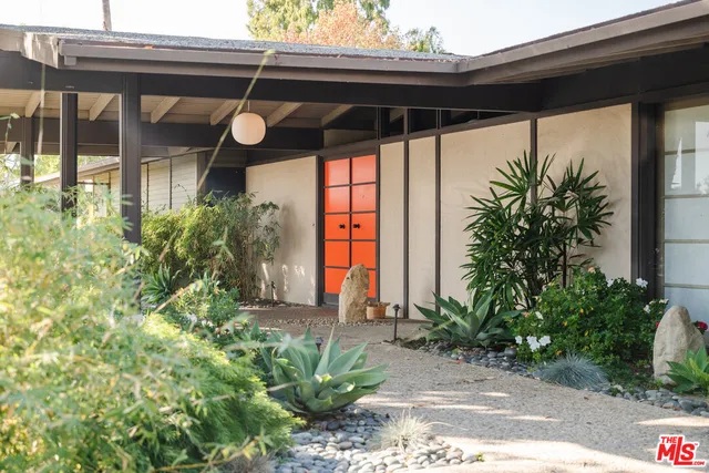 a view of a house with a small yard and plants