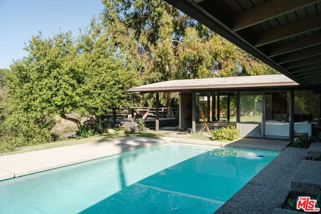 a view of a house with sitting area and garden