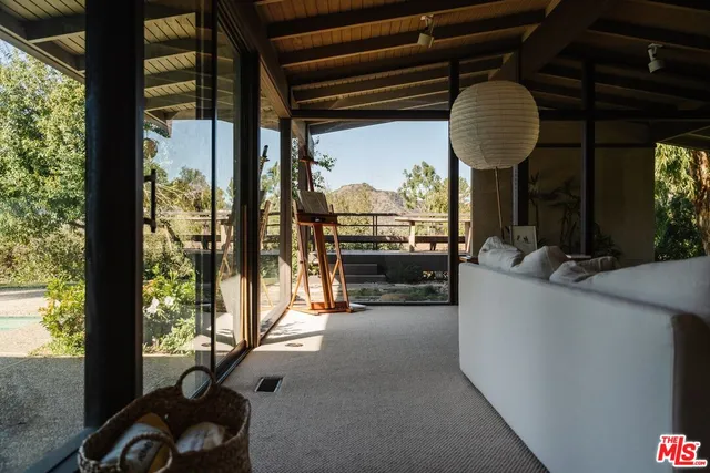 a living room filled with furniture and a large window
