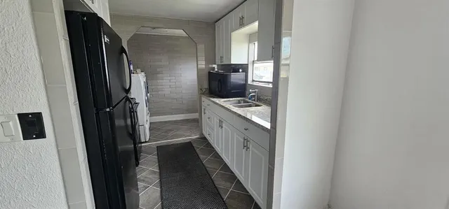 a kitchen with a sink and refrigerator