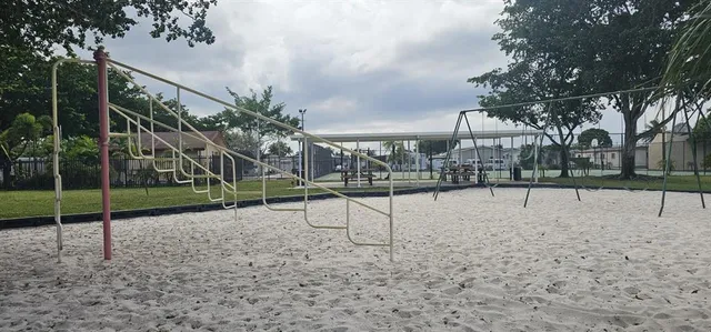a kitchen that has a sink cabinets counter space and appliances