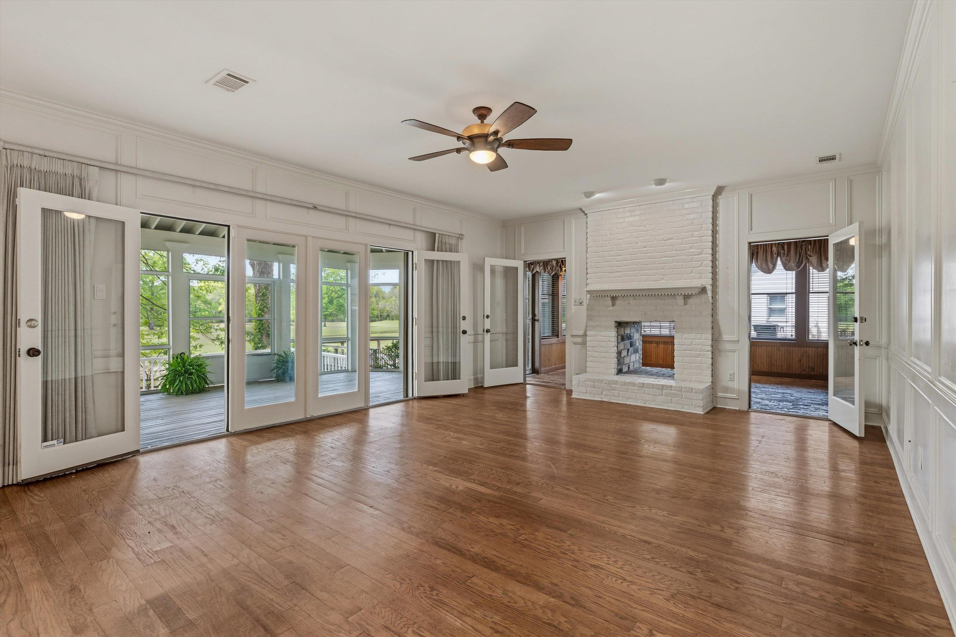 2783 West Levee Oaks Collierville, TN 38017 - Photo 12 of 40 a view of an empty room with window wooden floor and a kitchen