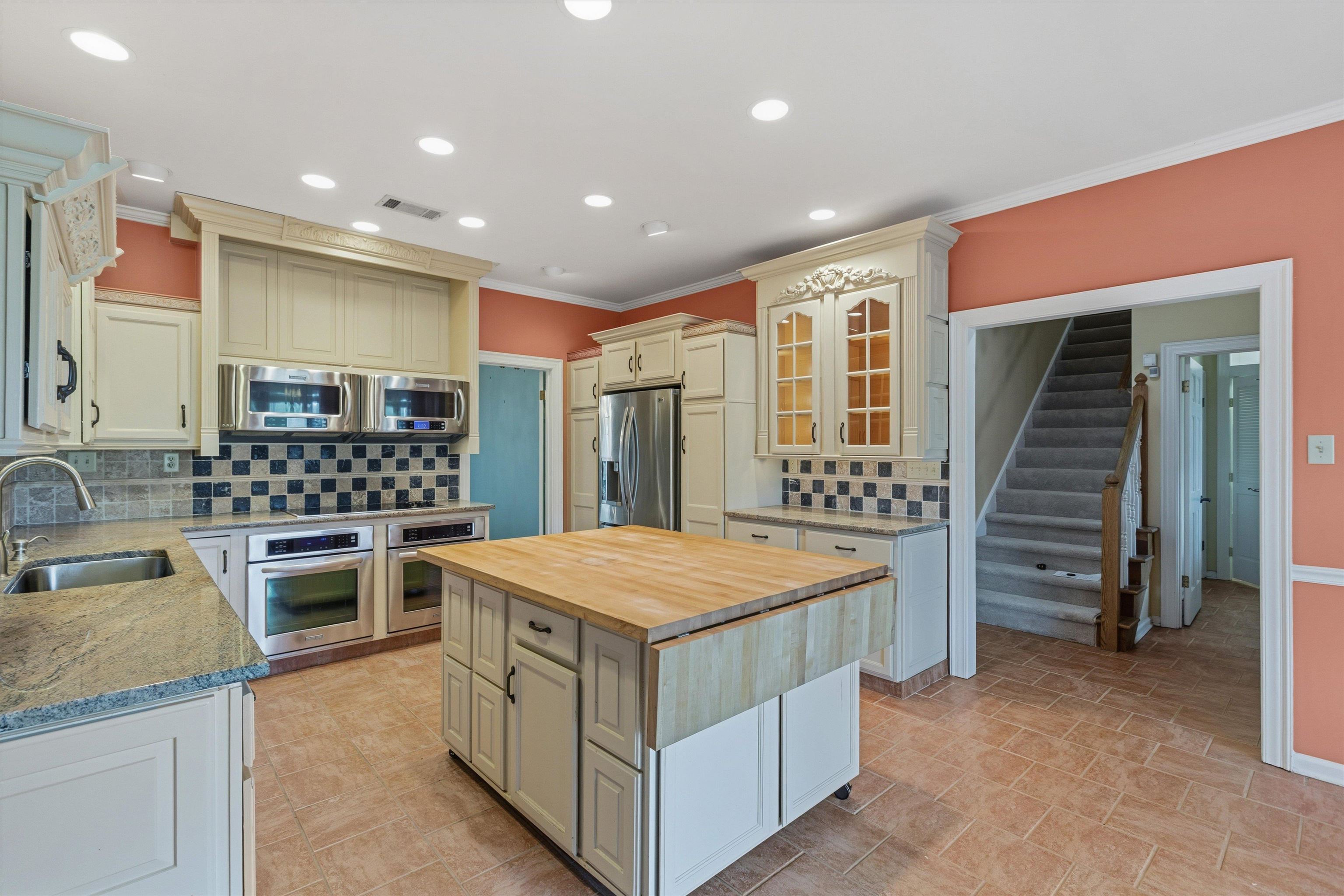 2783 West Levee Oaks Collierville, TN 38017 - Photo 16 of 40 a kitchen with stainless steel appliances kitchen island granite countertop a stove and a refrigerator