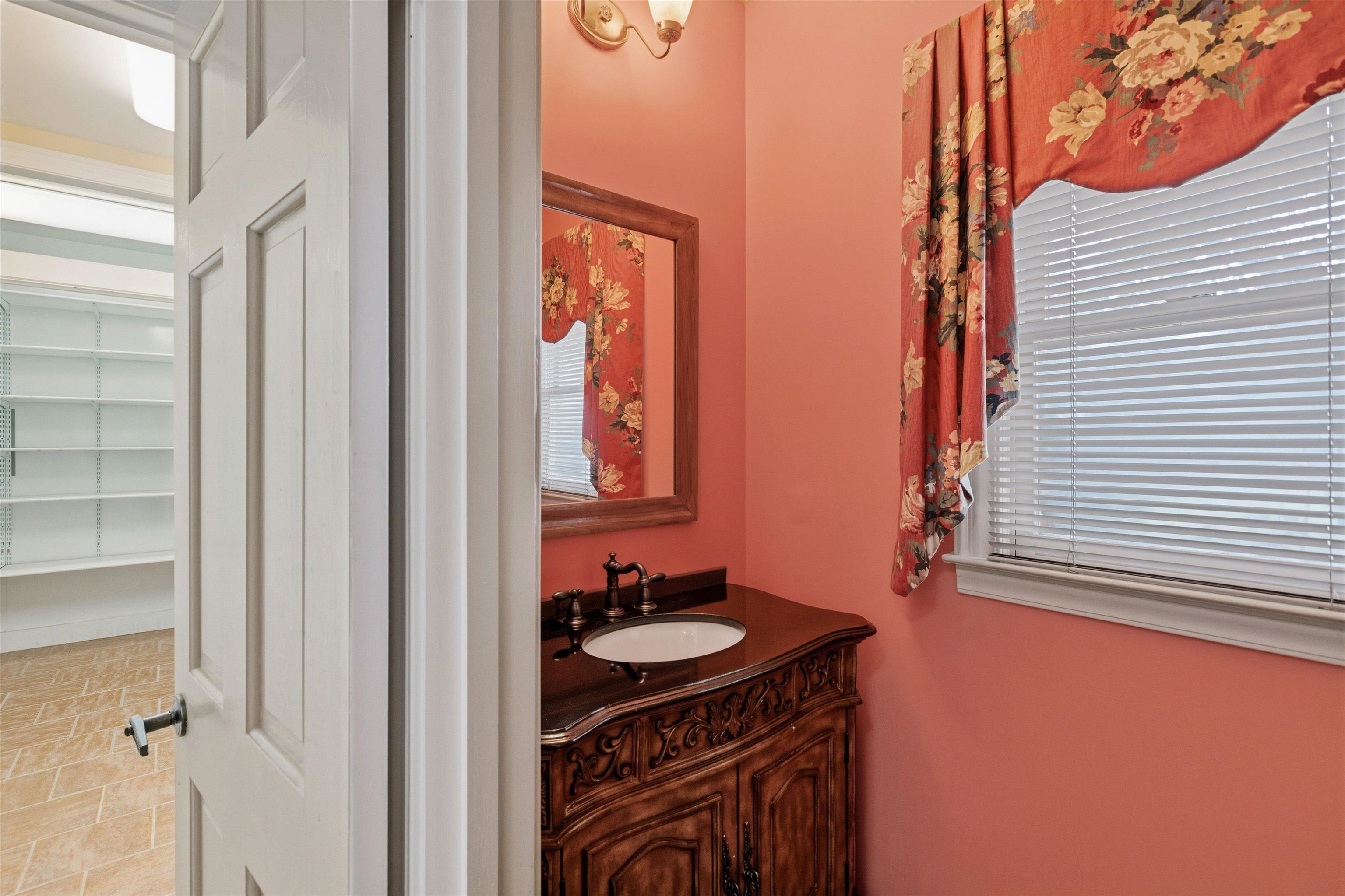 2783 West Levee Oaks Collierville, TN 38017 - Photo 22 of 40 a bathroom with a sink a mirror and a window