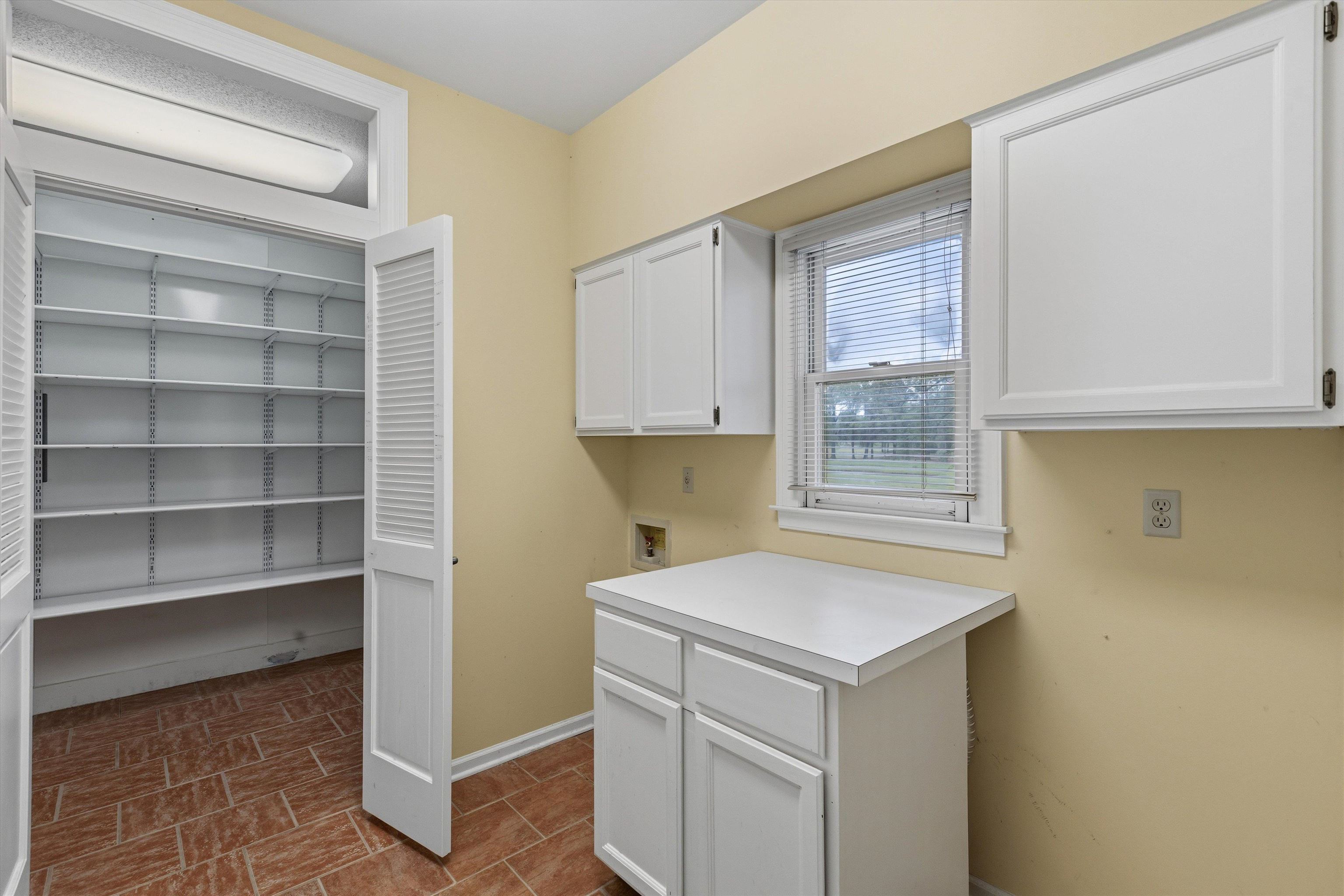 2783 West Levee Oaks Collierville, TN 38017 - Photo 23 of 40 a utility room with cabinets washer and dryer