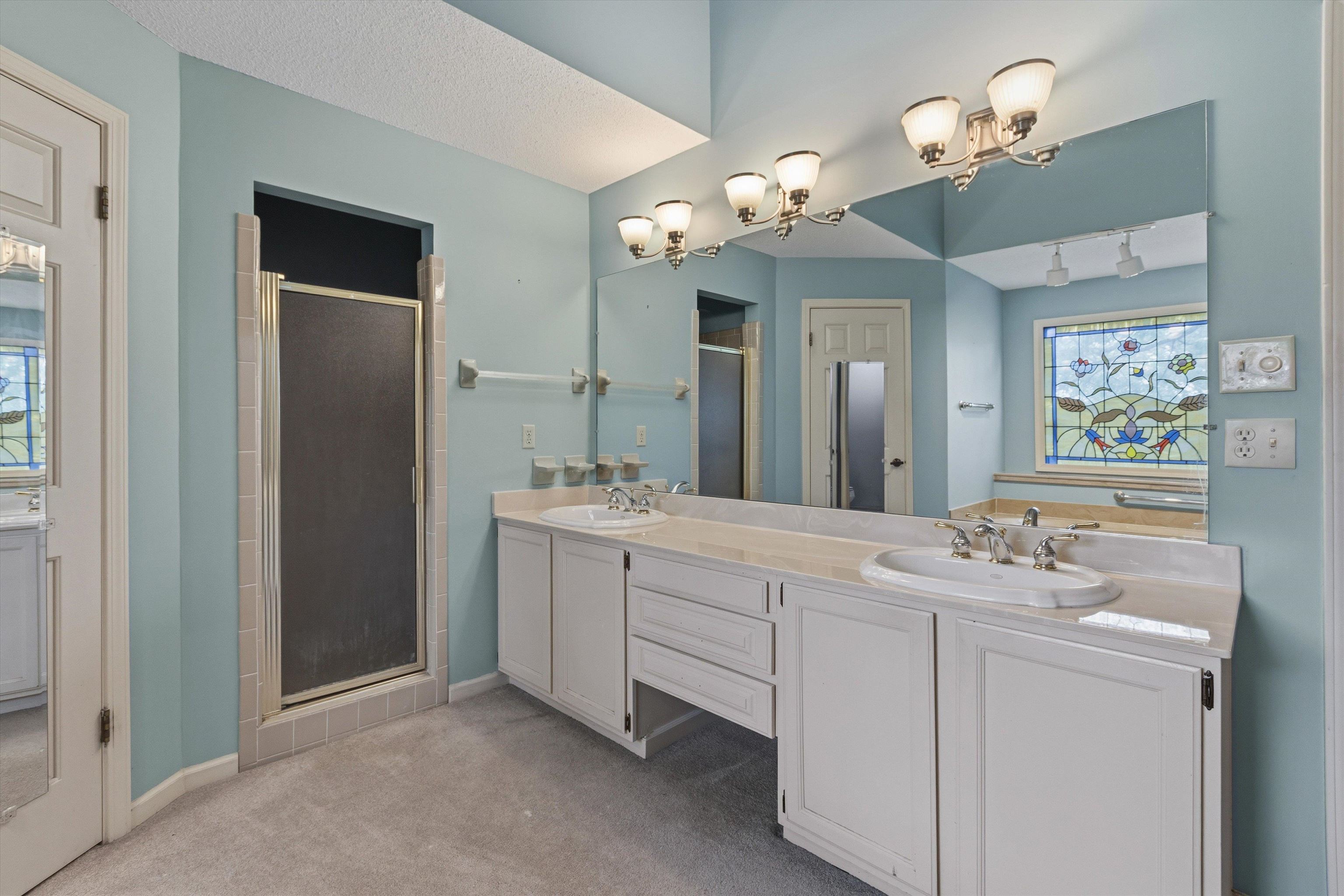 2783 West Levee Oaks Collierville, TN 38017 - Photo 27 of 40 a bathroom with a sink vanity and a mirror