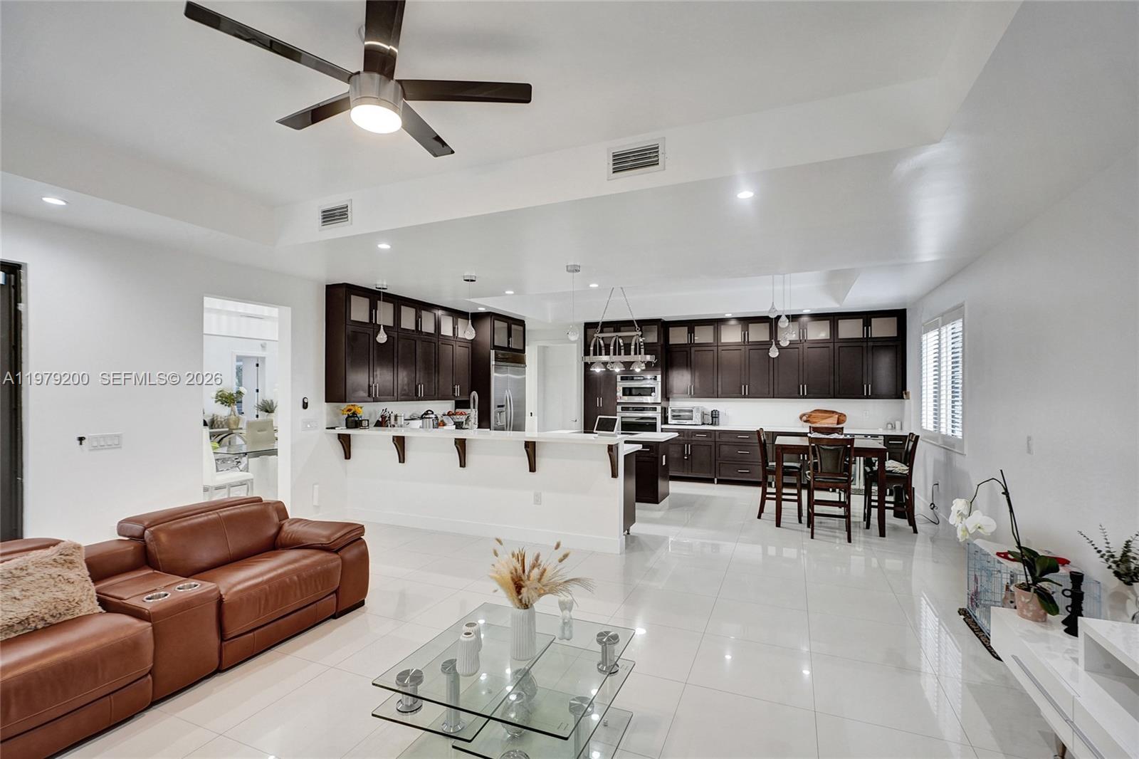 13676 Southwest 33rd Terrace Miami, FL 33175 - Photo 12 of 90 a living room with furniture and a flat screen tv