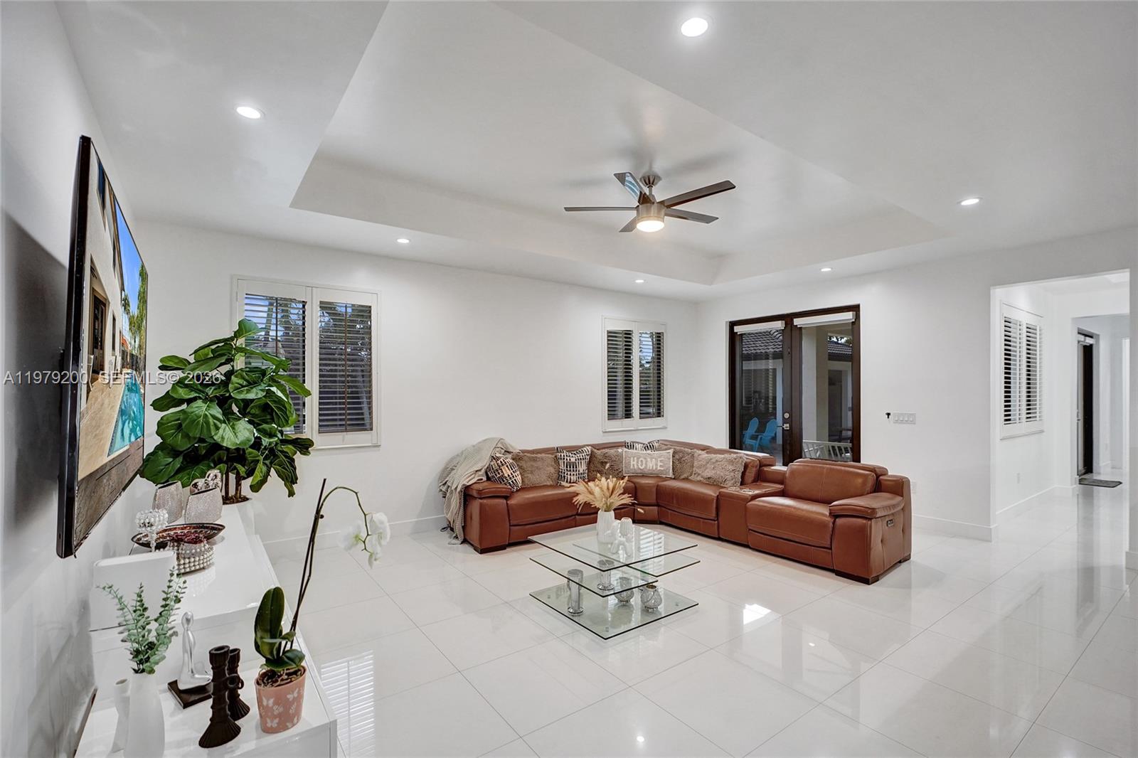 13676 Southwest 33rd Terrace Miami, FL 33175 - Photo 13 of 90 a living room with furniture potted plant and a flat screen tv