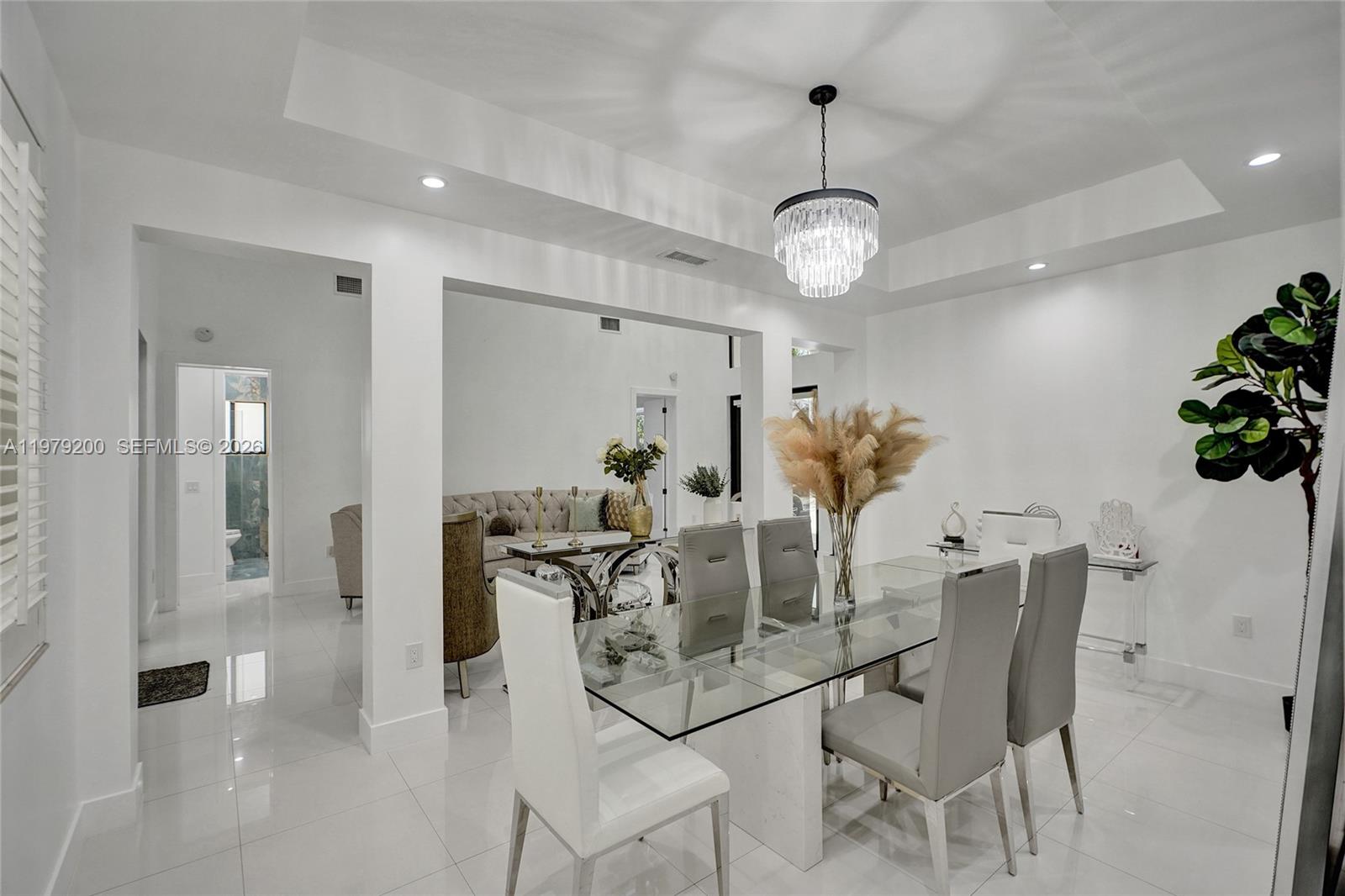 13676 Southwest 33rd Terrace Miami, FL 33175 - Photo 18 of 90 a dining room with furniture a chandelier and wooden floor