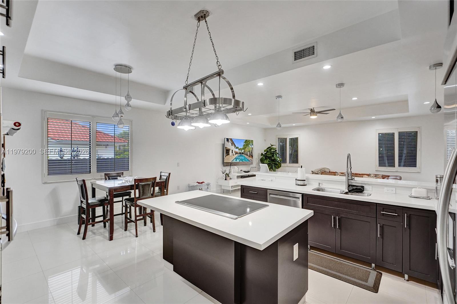13676 Southwest 33rd Terrace Miami, FL 33175 - Photo 23 of 90 a kitchen with a sink a counter space appliances and cabinets
