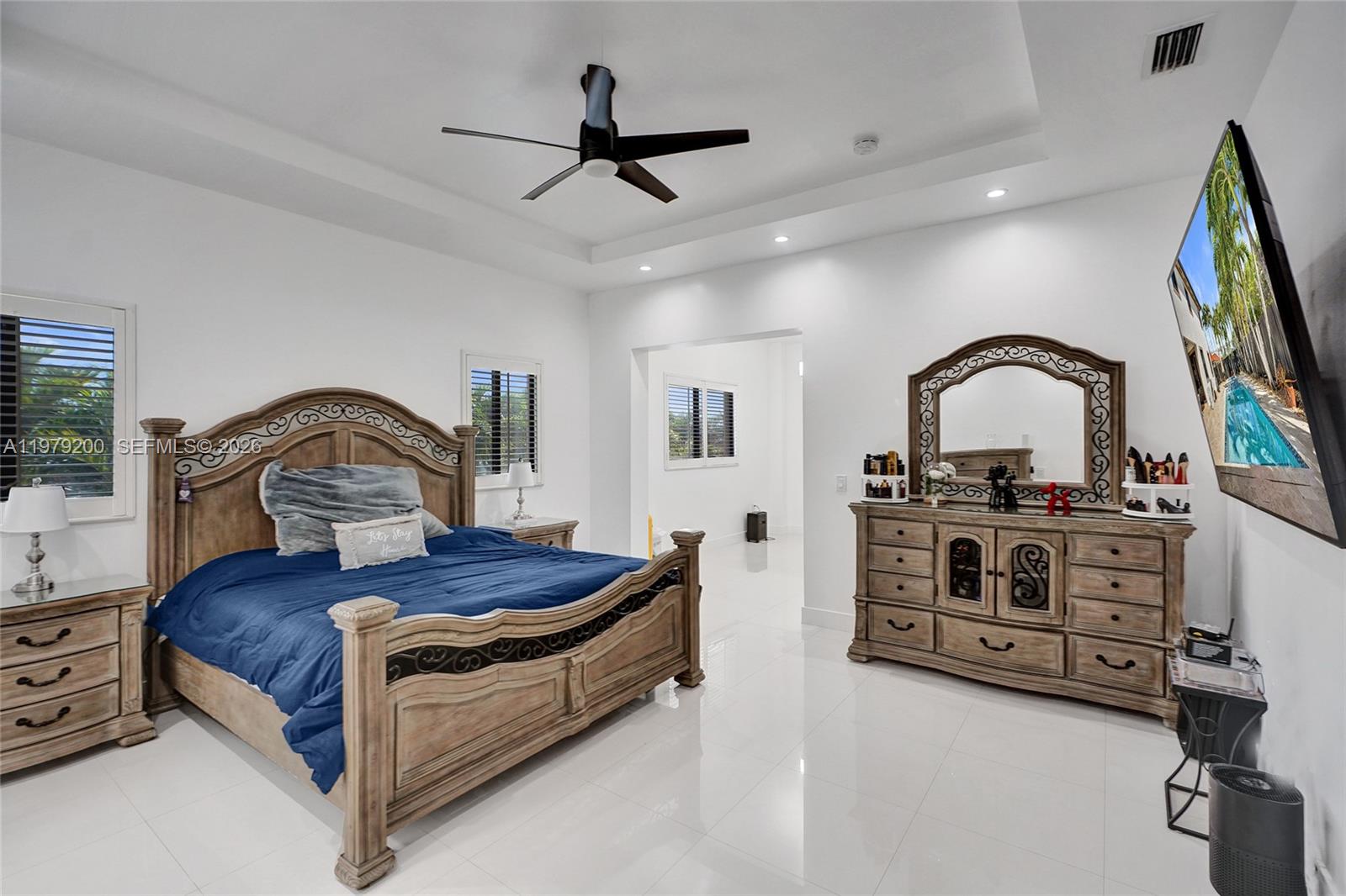 13676 Southwest 33rd Terrace Miami, FL 33175 - Photo 35 of 90 a bedroom with a bed and a flat tv screen on the dresser