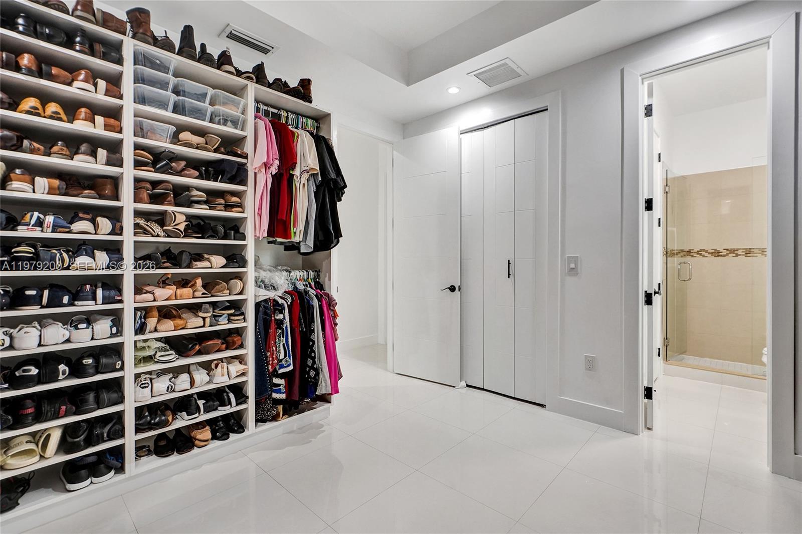 13676 Southwest 33rd Terrace Miami, FL 33175 - Photo 43 of 90 a view of walk in closet with clothes and shoes