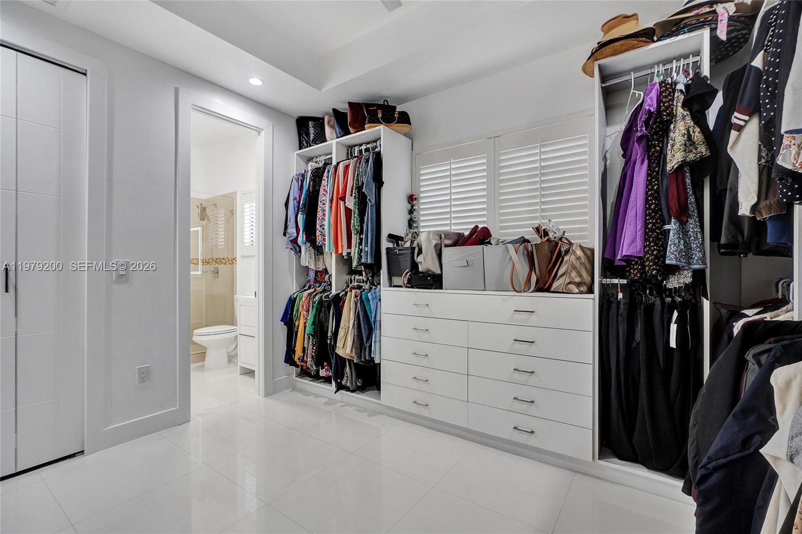 13676 Southwest 33rd Terrace Miami, FL 33175 - Photo 47 of 90 a view of walk in closet with clothes