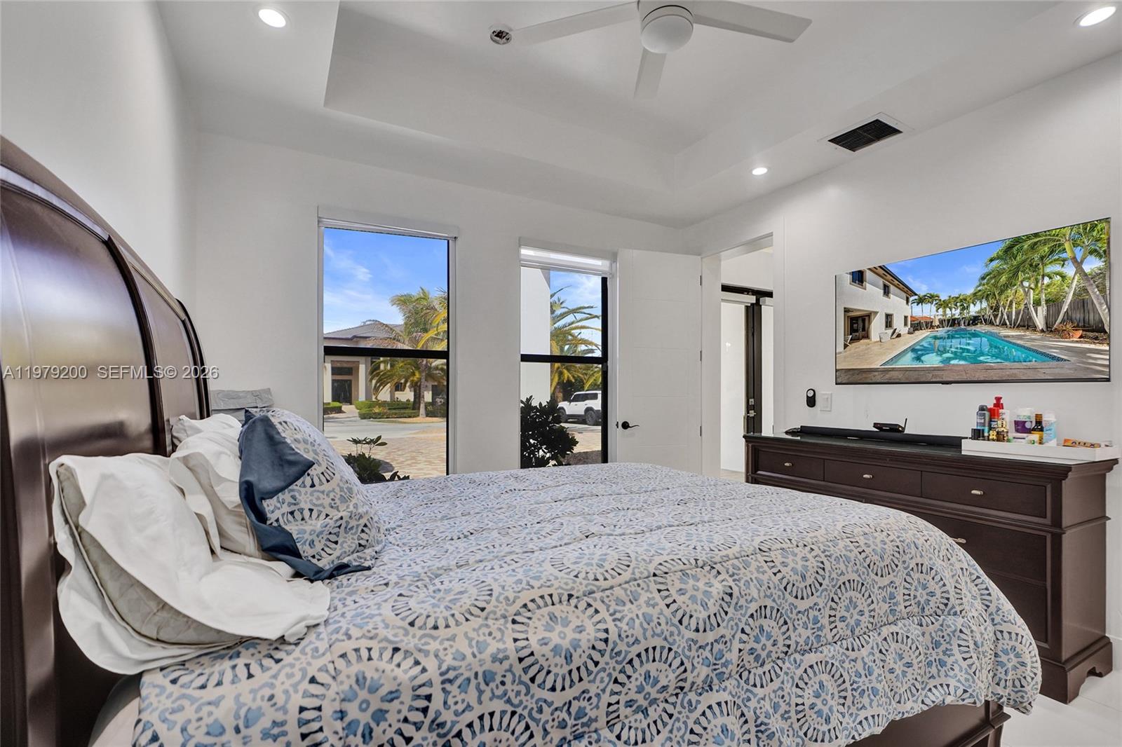 13676 Southwest 33rd Terrace Miami, FL 33175 - Photo 48 of 90 a bedroom with a bed and a flat tv screen on dresser