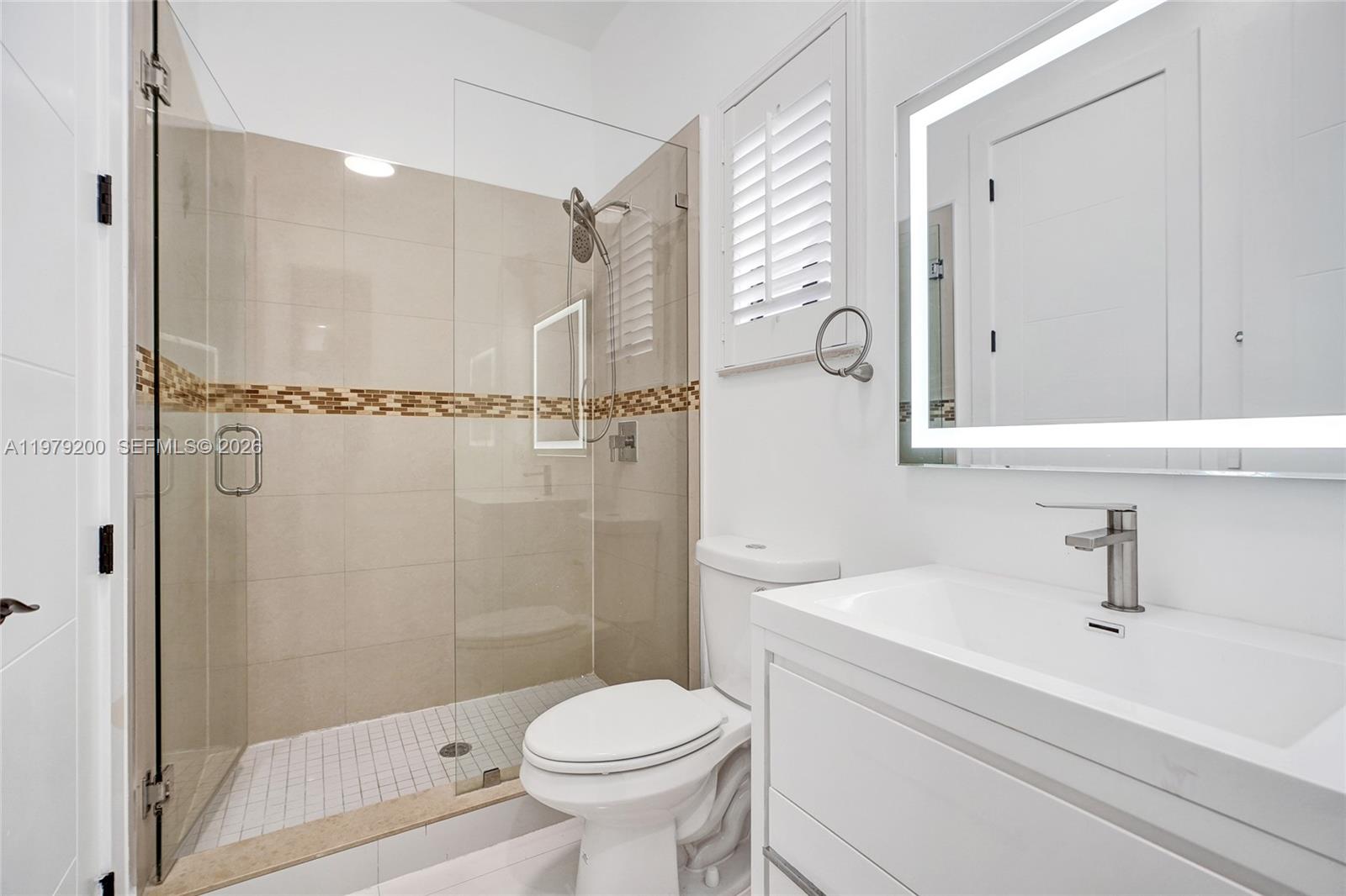 13676 Southwest 33rd Terrace Miami, FL 33175 - Photo 57 of 90 a bathroom with a shower a sink a toilet and a mirror