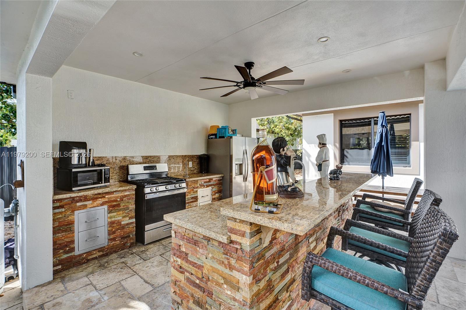 13676 Southwest 33rd Terrace Miami, FL 33175 - Photo 68 of 90 a kitchen with stainless steel appliances kitchen island granite countertop a stove and a sink